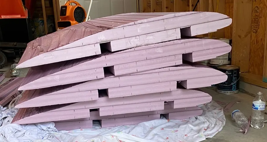 Stack of finished pink foam airfoil sections.